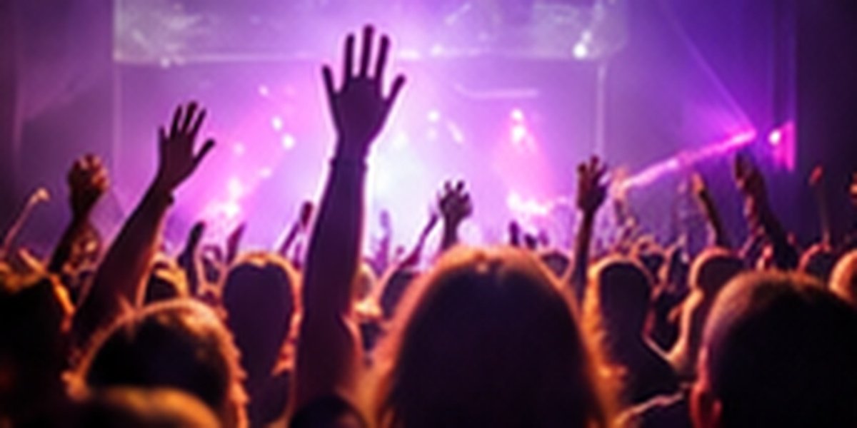 Concert crowd with hands raised at a youth festival